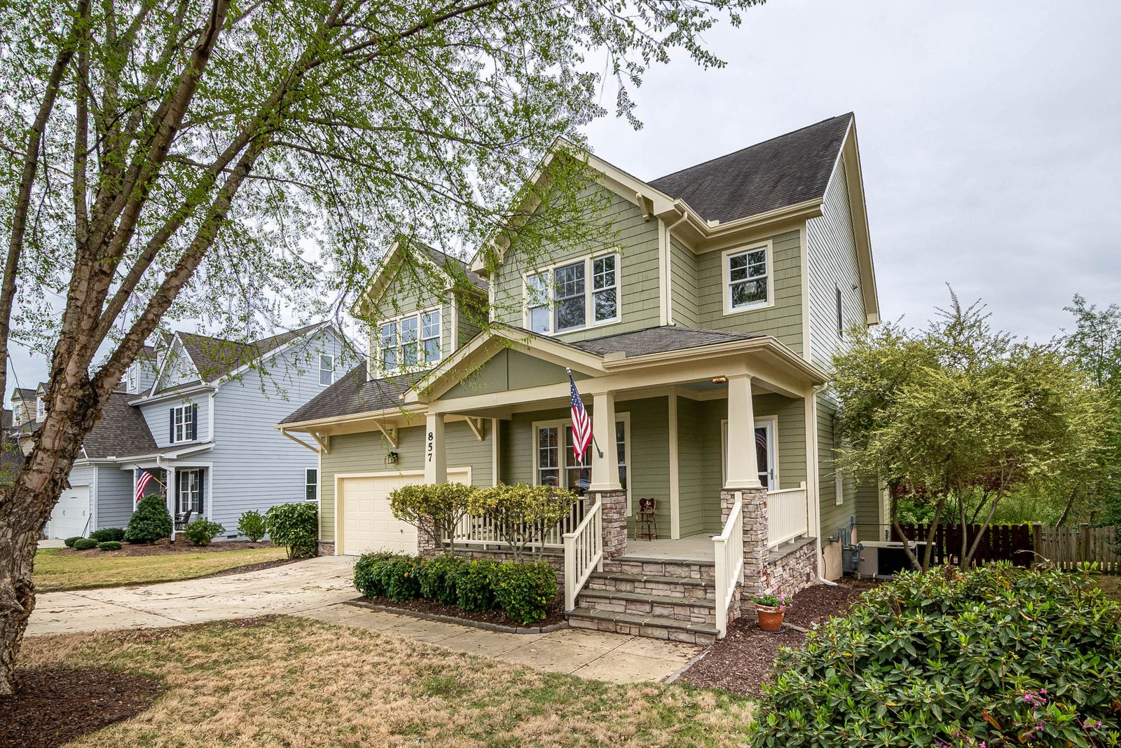 Suburban North Carolina home from the polybutylene construction era with a front porch and flag