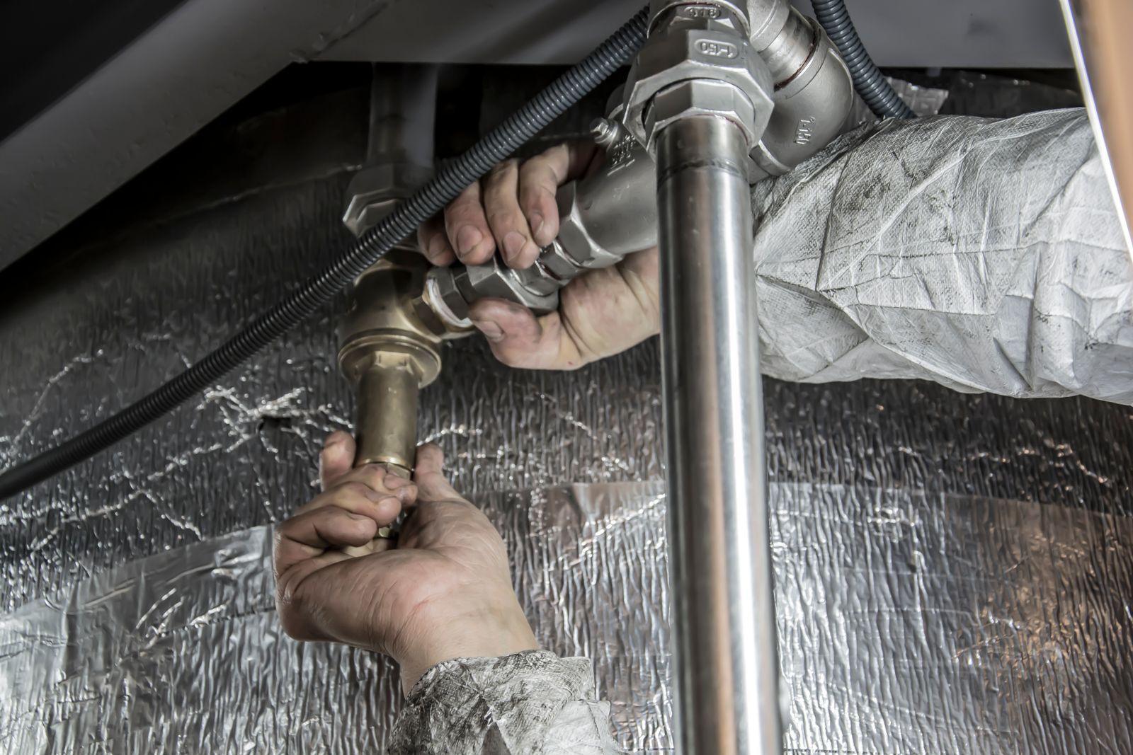 Licensed plumber replacing old polybutylene supply pipe with new piping in Wilmington NC
