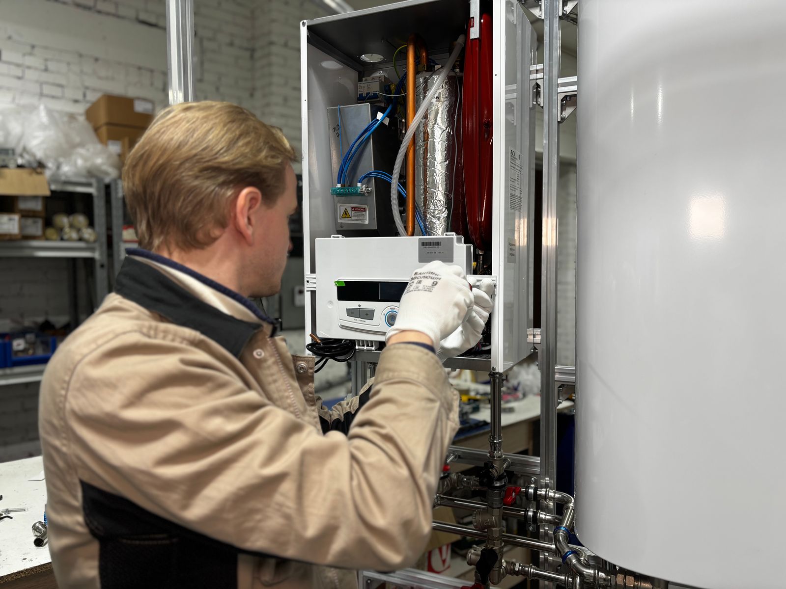 Technician installing a replacement water heater in a home utility room in Wilmington NC